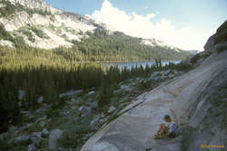 Scott at the base of Guppie Wall, Tenaya Lake behind