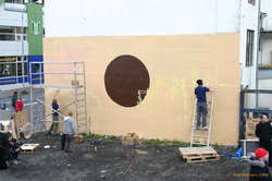 Big pieces require serious infrastructure.  These guys had 3-4 boxes of different paints and rollers