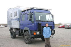 Tanja poses with the monster truck for scale