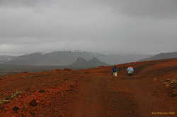 Ute and Tanja walk along, blissfully ignorant of what is about to strike