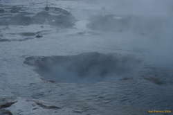 Water flows back into the gaping maw of Strokkur