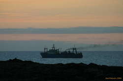 Grimy old boat heading out to sea