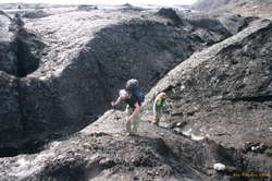 Trudging around the toe of the glacier, trying to get across the river