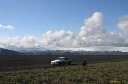 A micra pulled up to the edge of Lake Sand