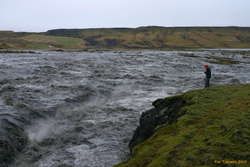 Iveta peering down at the torrent by Skaftárdalur