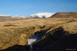 First of many waterfalls on the way up Skógá. Eyjafjallajökull in the background