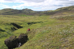 Mum looking at plants in a creek on Blakkdalsháls