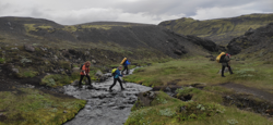 The girls crossing a creek